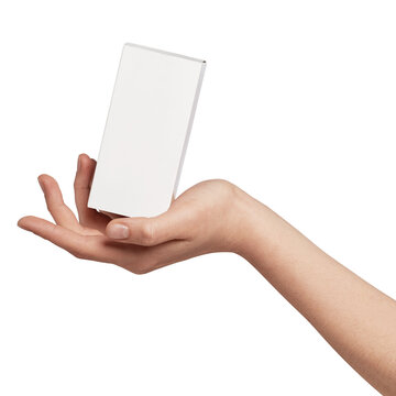 Human hand presenting a small white rectangular cardboard box with empty copy space, suitable for product mock-ups, cosmetic packaging, or small business branding, isolated on background