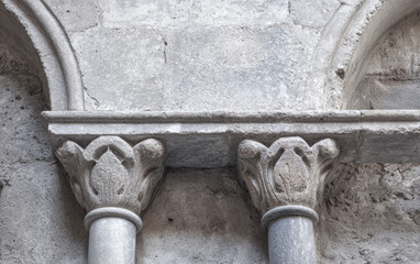 Detail of stone columns and ornate capitals in an ancient building located in a historic area