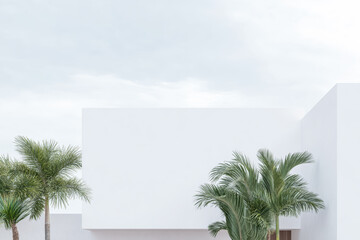 Modern building design with palms under cloudy sky in urban area