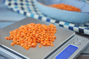 Weighing orange lentils in the kitchen