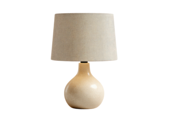 Beige lamp with tapered shade on dark backdrop