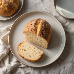 Obraz premium Fresh Homemade Bread Loaf with Slice on Plate, Rustic and Soft Texture