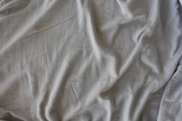 Soft gray fabric lying on a flat surface in a room
