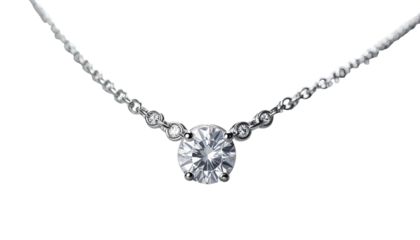 A close-up shot of a delicate necklace featuring a large, brilliant-cut gemstone. The gem sparkles, suspended by a slender chain