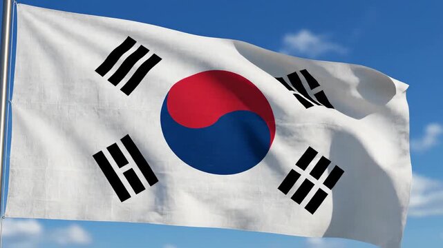 A white flag with four black trigrams and a central emblem of red and blue, against blue sky