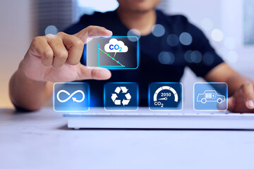 CO2 emission reduction concept with men in black on virtual interface for environment information to sustainable development, recycle and electric vehicle represent to zero within 2050