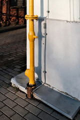 Gas pipe installed next to a lightning protection conductor on a building wall. Risky and unsafe infrastructure solution highlighting safety violations, engineering mistakes