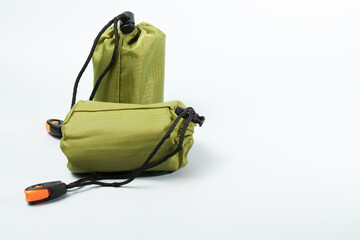 Two green ripstop nylon stuff sacks, with black drawstrings and cord locks, offering lightweight and compact storage for outdoor gear