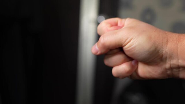 The guy shows two fingers on his hand, the piss symbol.