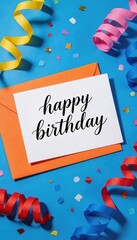 happy birthday greeting card with calligraphy text on white paper and orange envelope, colorful confetti and streamers background, festive celebration flat lay