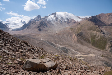 High altitude mountain landscape in August. Majestic peaks and glaciers of Trans-Ili Alatau at 3000 meters above sea level, Almaty, Kazakhstan.