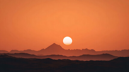 Sun Above Distant Mountain Peaks at Dusk sunset mountains