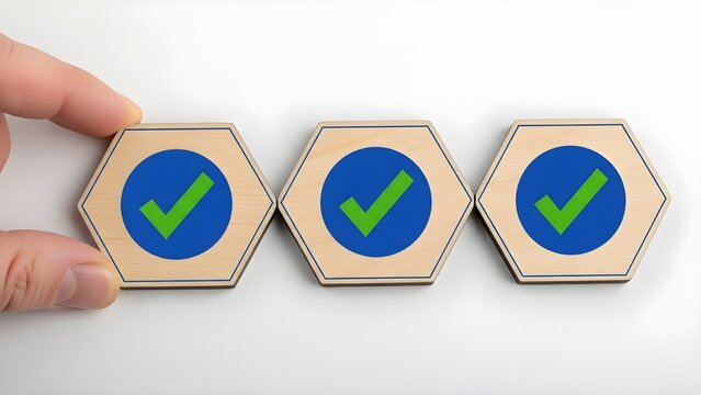 Hand placing wooden hexagonal tile marked with a green checkmark symbolizing completion, quality assurance, or successful process implementation