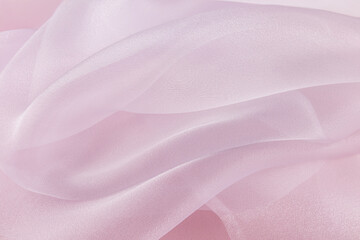 Chic large air waves of white organza on a pink background. stylish wedding background. light airy silk. shine of the fabric