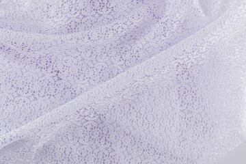 Background of white folds of openwork fabric with floral pattern. soft folds. fabric texture. A copy space. wedding background.