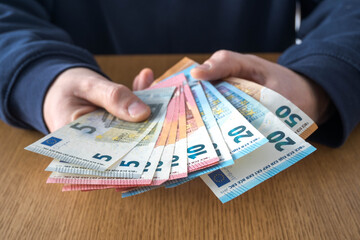 European currency in a man's hands.
