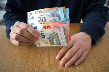European currency in a man's hands.
