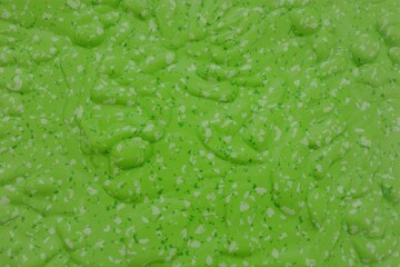 Bright Green Textured Surface with White and Dark Green Flecks background abstract