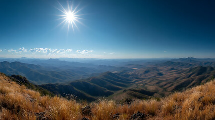 Vast Mountain Landscape Under Bright Sun and Blue Sky