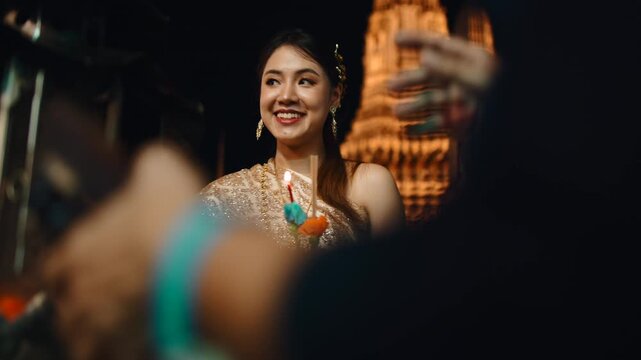 Two beautiful thai women celebrating loi krathong festival at wat arun