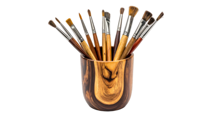 Artistic close-up view of paint brushes displayed in a textured wooden cup
