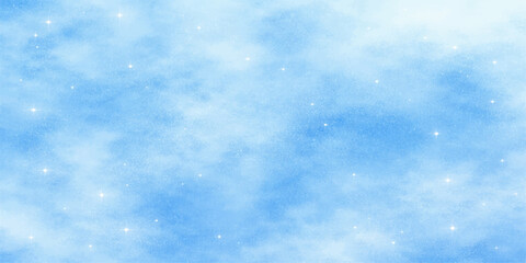 Fototapeta premium A beautiful blue winter sky background features bright white fluffy clouds and falling snowflakes in a clear natural light