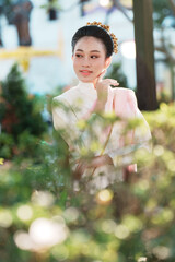 Graceful woman in traditional dress natural light elegance