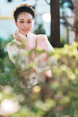 Graceful woman posing in garden urban setting portrait