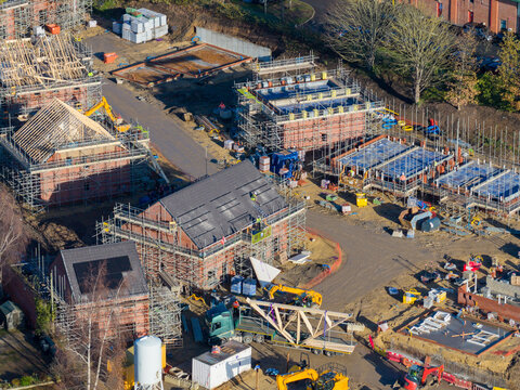 Aerial drone photo of the town of Ripon in North Yorkshire in the UK showing a housing development site building new homes in the autumn time with workmen working on the homes