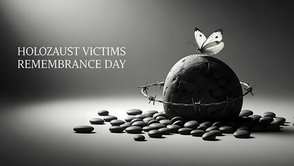 Holocaust remembrance day concept with butterfly on stone wrapped in barbed wire surrounded by pebbles symbolizing victims and freedom with symbolic