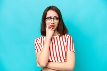Young Ukrainian woman isolated on blue background nervous and scared