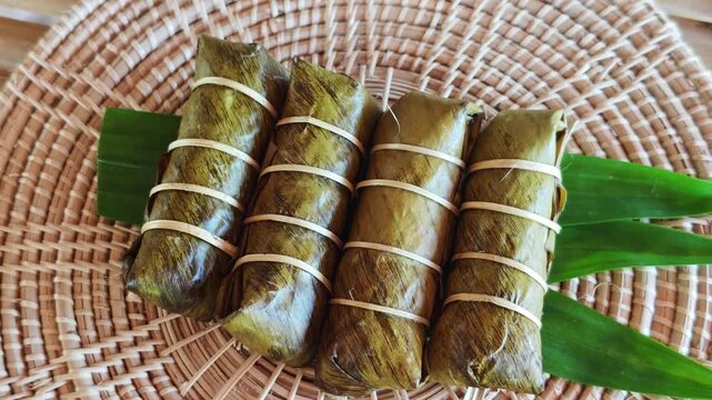 Khao Tom Mud, Traditional Thai dessert sticky rice, coconut milk and banana wrapped in banana leaves