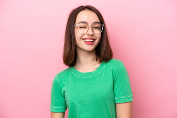 Fototapeta premium Young Ukrainian woman isolated on pink background With glasses and happy expression
