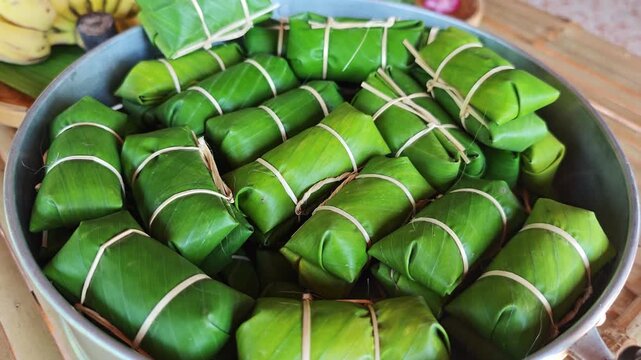 Khao Tom Mud before cooking,Traditional Thai dessert sticky rice, coconut milk and banana wrapped in banana leaves
