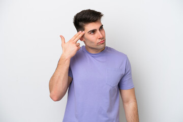 Fototapeta premium Young caucasian man isolated on white background with problems making suicide gesture