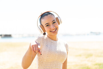 Young moroccan girl  at outdoors listening music