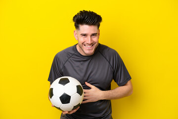 Handsome young football player man isolated on yellow background smiling a lot