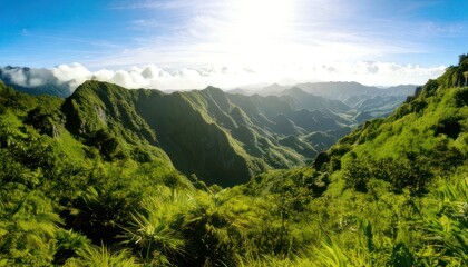 Mountain range with lush green foliage under a bright blue sky and sunlight