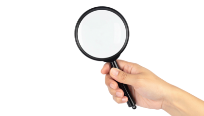 A human hand holding a magnifying glass against a solid black background