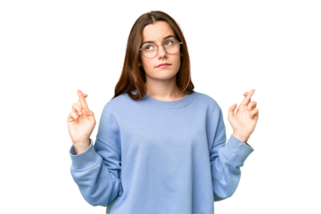 Teenager girl over isolated chroma key background with fingers crossing and wishing the best
