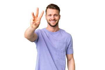 Young handsome caucasian man over isolated chroma key background happy and counting three with...
