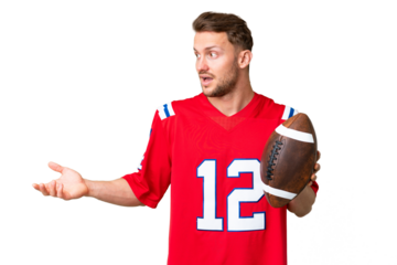 Young caucasian man playing rugby over isolated chroma key background with surprise expression while looking side