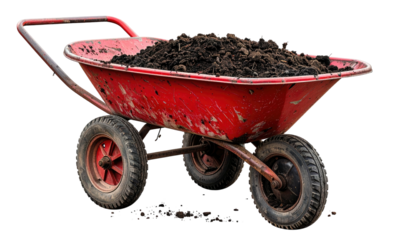 A red two-wheeled cart is filled with rich, dark soil, ready for garden work