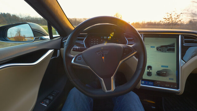 POV Male driver sitting in a self navigating car driving through the countryside