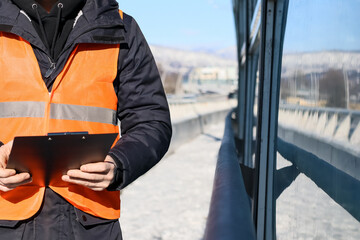 Snowy highway bridge with urban and mountain backdrop