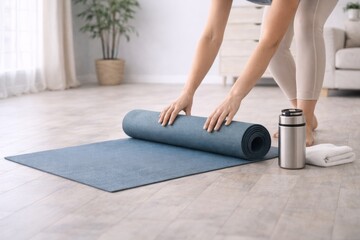 Preparing yoga mat for home workout routine