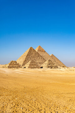 The Great Pyramids of Giza rise from the Egyptian desert in the evening light