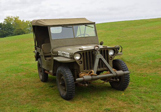 Vintage Ford GPW Willys Jeep parked on grass