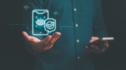 Man using smartphone security icon with biometric eye scan and verified shield symbol, mobile data protection, digital privacy, cybersecurity, identity verification, secure smart technology concept.