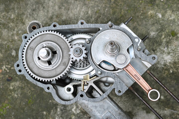 Detail of the inside of an Italian two-stroke scooter engine containing transmission gears, crankshaft, wheel axles, etc. Photo taken from a close distance with a flat lay